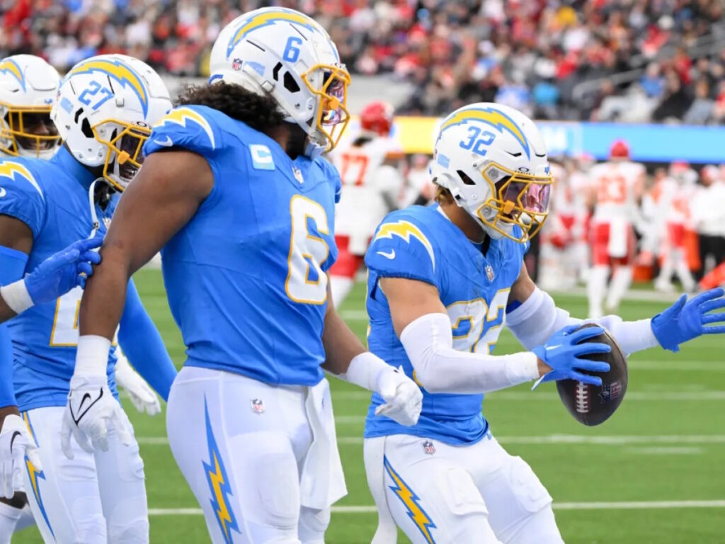 several people in American football uniforms with a ball